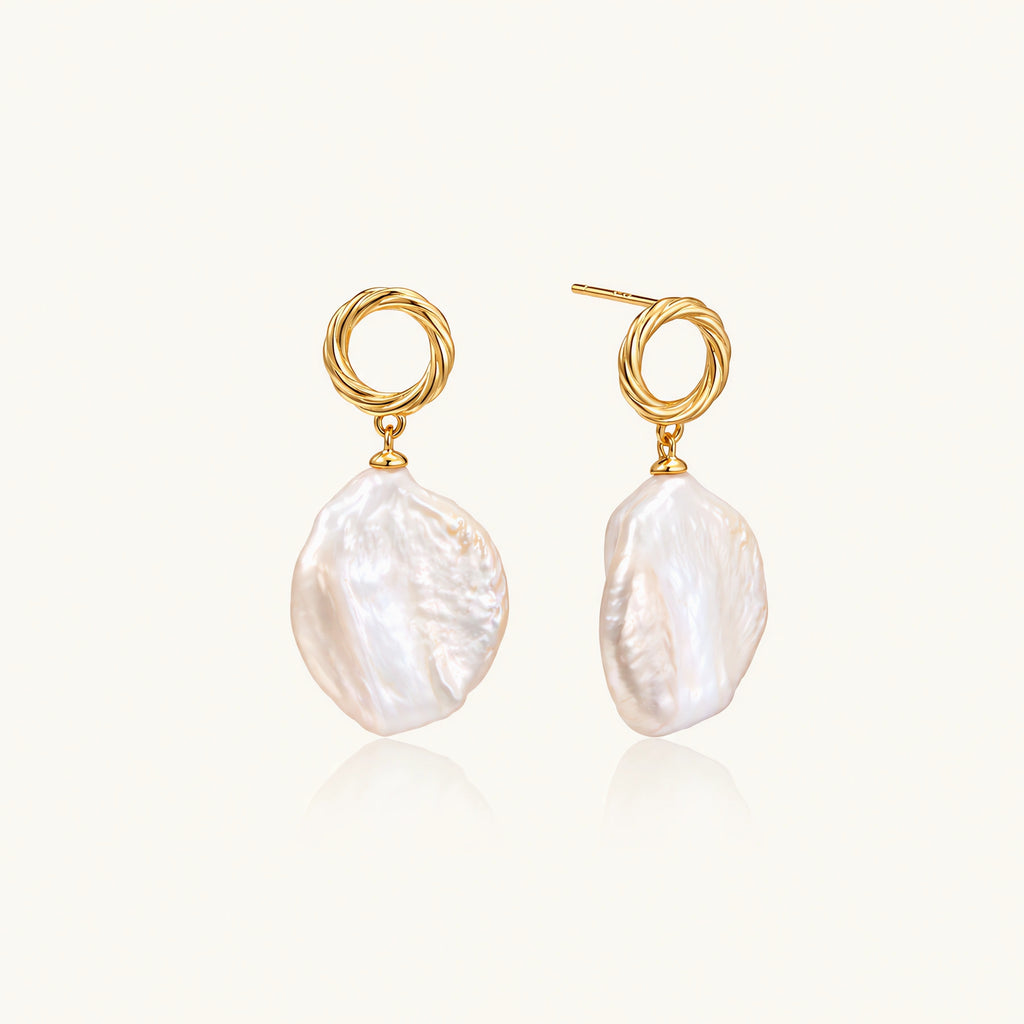 18K gold vermeil twisted circle studs with organic white baroque pearl drops on cream background