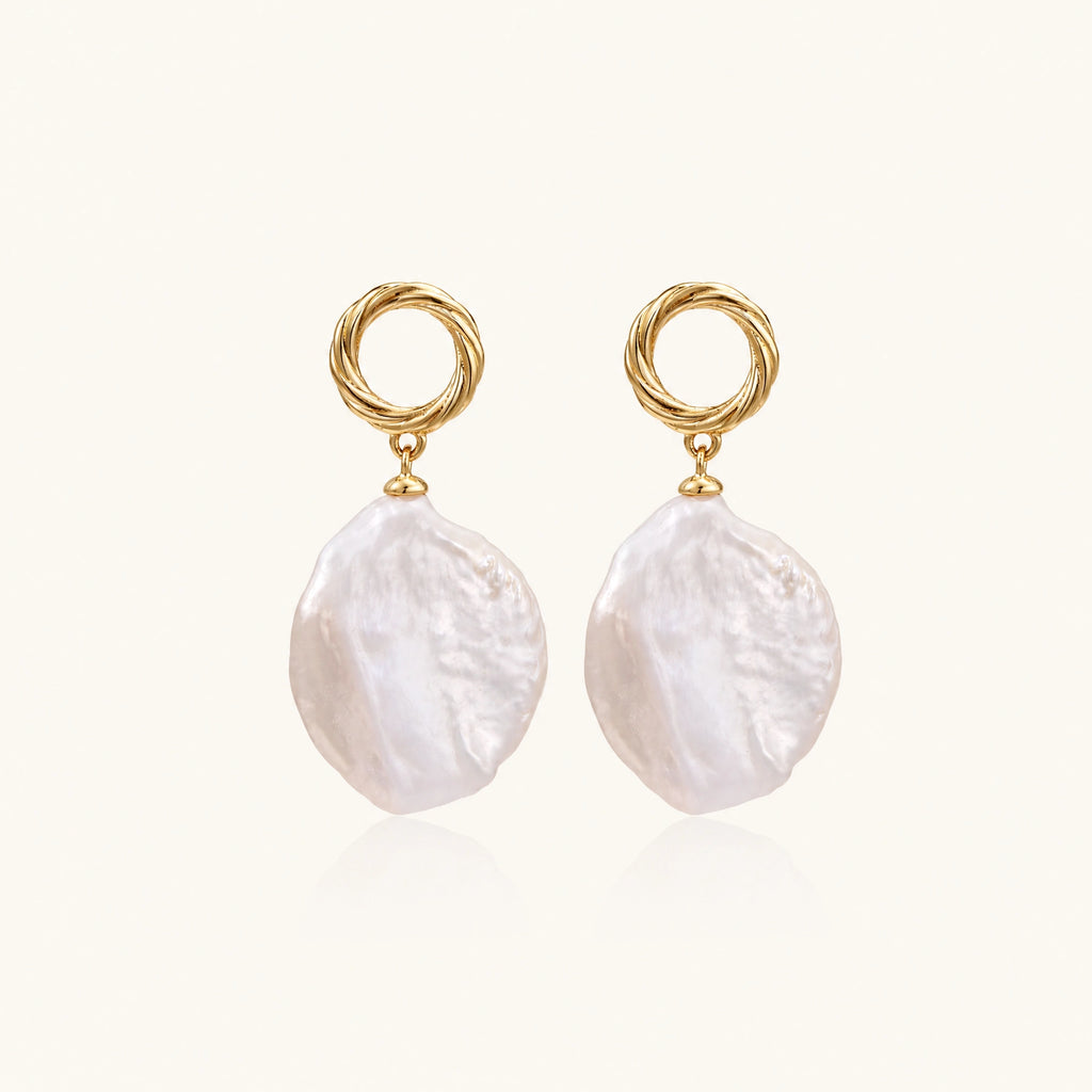 18K gold vermeil twisted circle studs with organic white baroque pearl drops on cream background