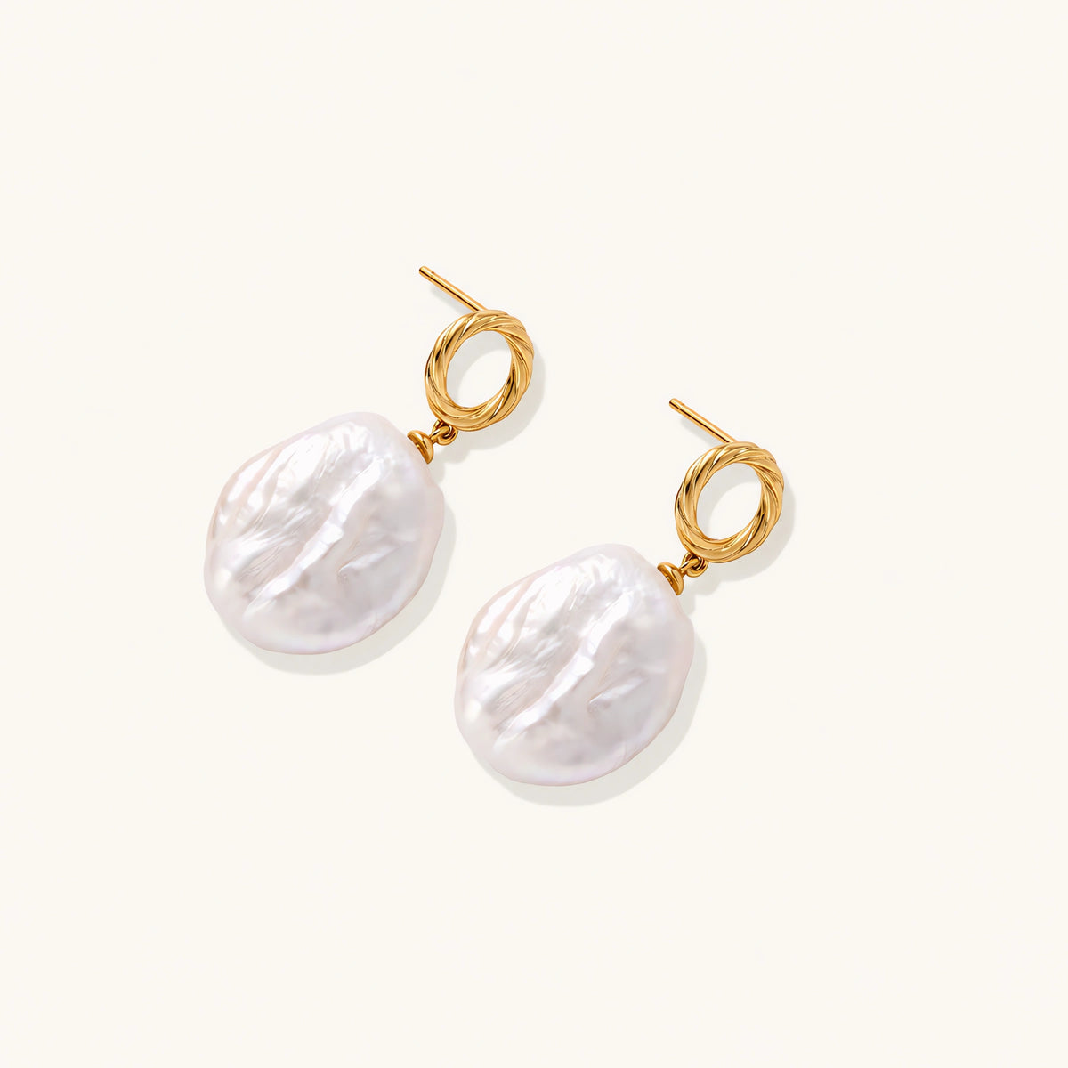 18K gold vermeil twisted circle studs with organic white baroque pearl drops on cream background
