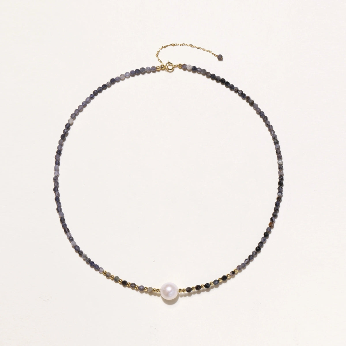 Dainty necklace with faceted purple iolite beads, gold vermeil accents, and central pink-white freshwater pearl.