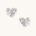 Pair of sculptural white gold-plated stud earrings with twisted ribbon design and sparkling zirconia stones on cream background