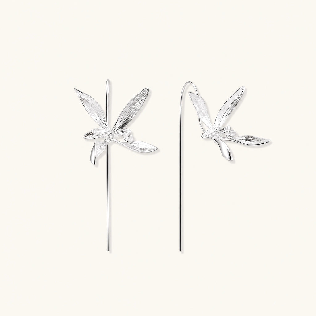 Delicate sterling silver dragonfly earrings with textured wings and curved threader hooks on white background