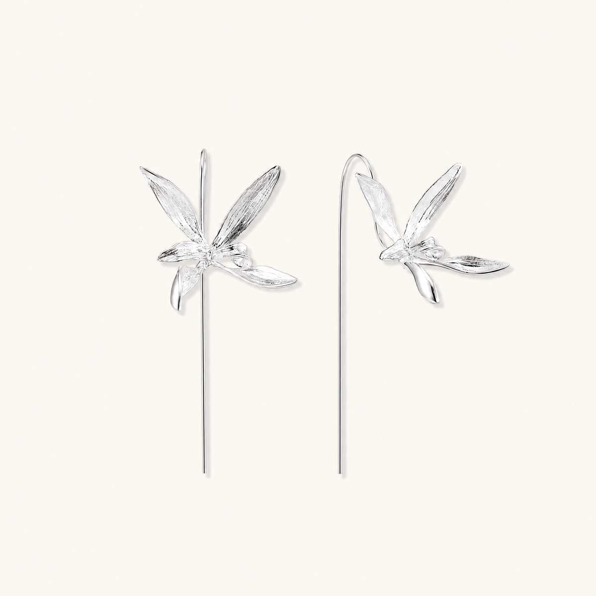 Delicate sterling silver dragonfly earrings with textured wings and curved threader hooks on white background