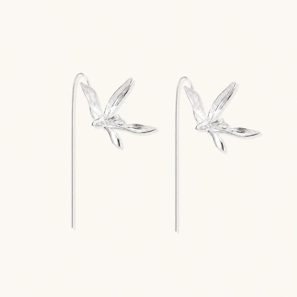 Delicate sterling silver dragonfly earrings with textured wings and curved threader hooks on white background