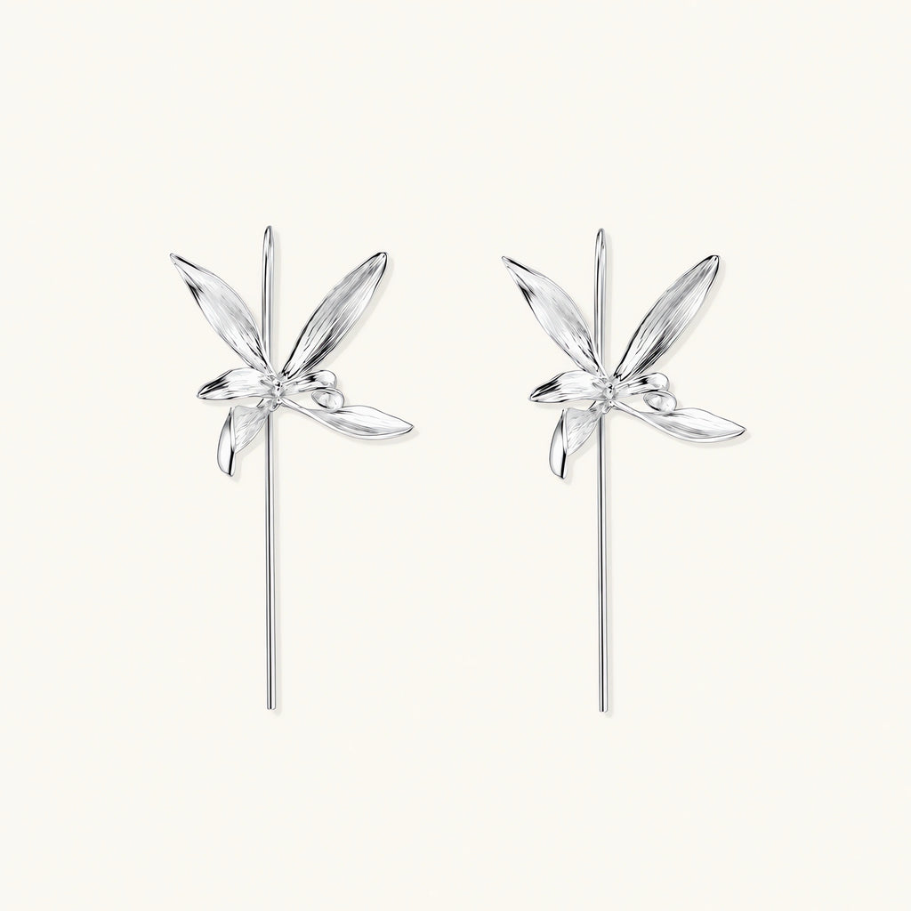 Delicate sterling silver dragonfly earrings with textured wings and curved threader hooks on white background